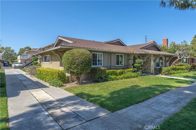 2619 W Aurora St, Santa Ana, CA 92704 - single story home with a front yard, stone siding, stucco siding, and a chimney