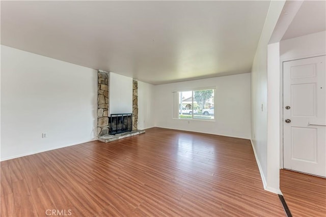 2619 W Aurora St, Santa Ana, CA 92704 - unfurnished living room with wood finished floors and a fireplace