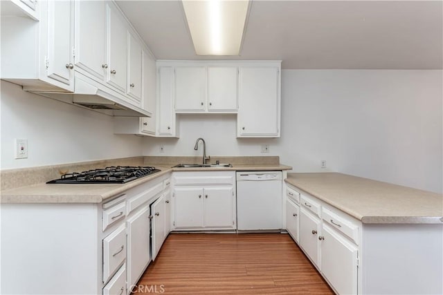2619 W Aurora St, Santa Ana, CA 92704 - kitchen with dishwasher, gas cooktop, a peninsula, light wood-type flooring, and white cabinets