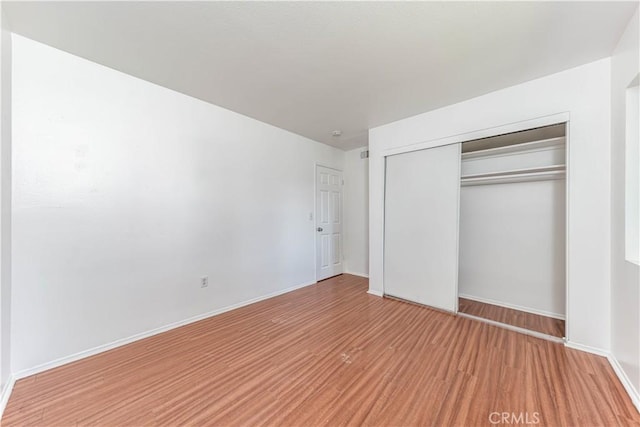 2619 W Aurora St, Santa Ana, CA 92704 - unfurnished bedroom with light wood-style floors, a closet, and baseboards