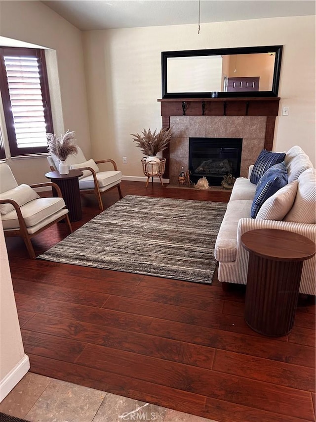228 Pisa Ct, Merced, CA 95341 - living area featuring baseboards, a fireplace, and wood finished floors