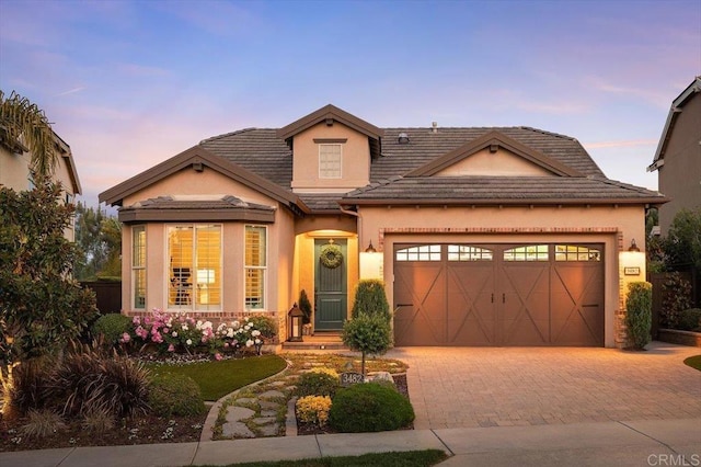 3482 Corte Fortuna, Carlsbad, CA 92009 - view of front of home featuring a garage, decorative driveway, and stucco siding