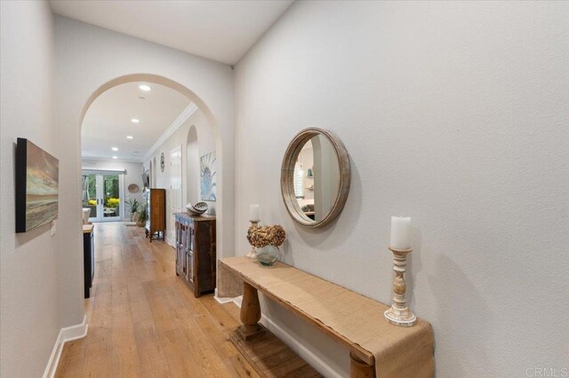 3482 Corte Fortuna, Carlsbad, CA 92009 - corridor featuring arched walkways, light wood-type flooring, baseboards, recessed lighting, and crown molding