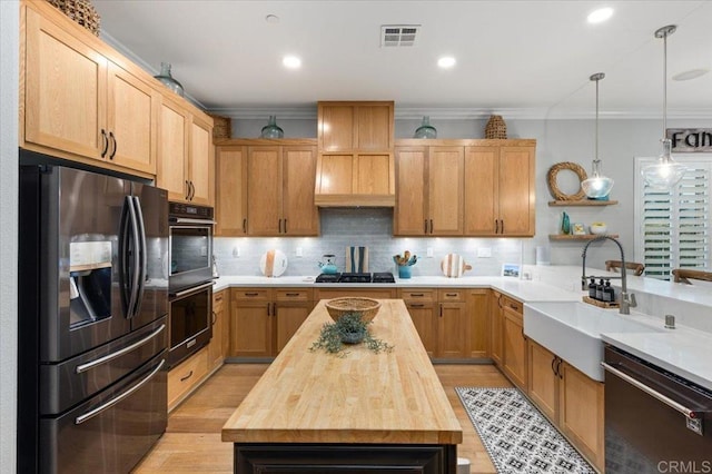 3482 Corte Fortuna, Carlsbad, CA 92009 - kitchen with stainless steel fridge, butcher block countertops, dishwasher, double oven, and backsplash