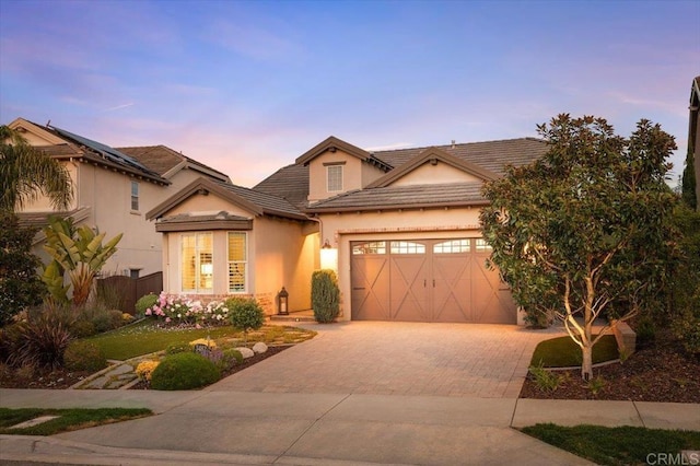 3482 Corte Fortuna, Carlsbad, CA 92009 - traditional-style house featuring decorative driveway, an attached garage, stucco siding, and a tile roof