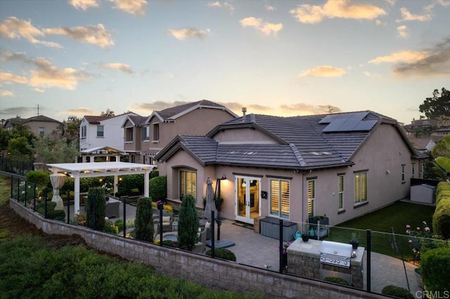 3482 Corte Fortuna, Carlsbad, CA 92009 - rear view of property with french doors, a patio area, a pergola, solar panels, and exterior kitchen