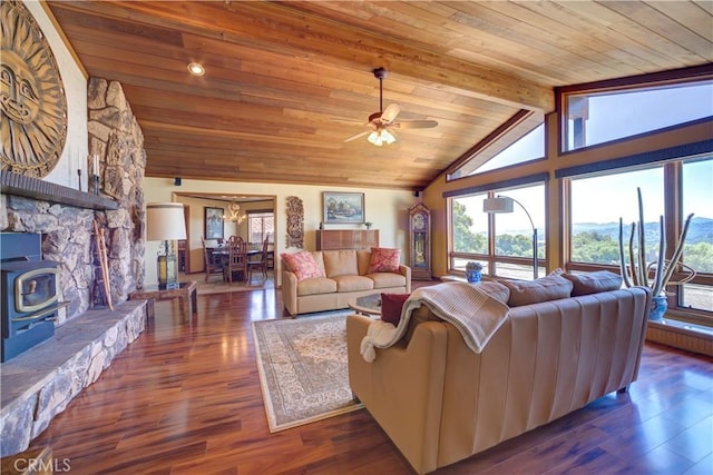 living area with wooden ceiling, a ceiling fan, wood finished floors, and a wood stove