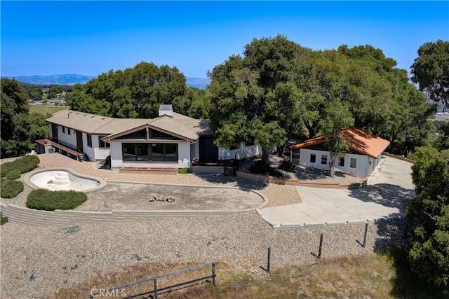 view of front of house featuring fence and a chimney