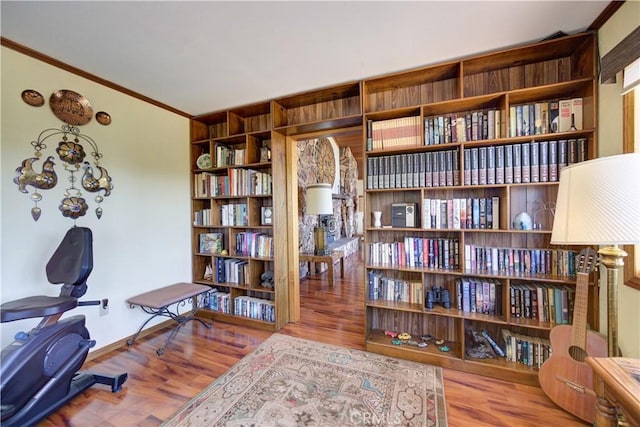 living area featuring crown molding and wood finished floors