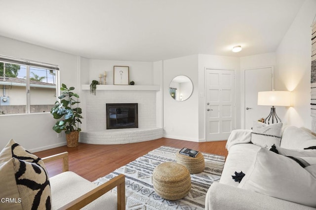 600 Good Hope St, Oak View, CA 93022 - living room featuring baseboards, wood finished floors, and a brick fireplace