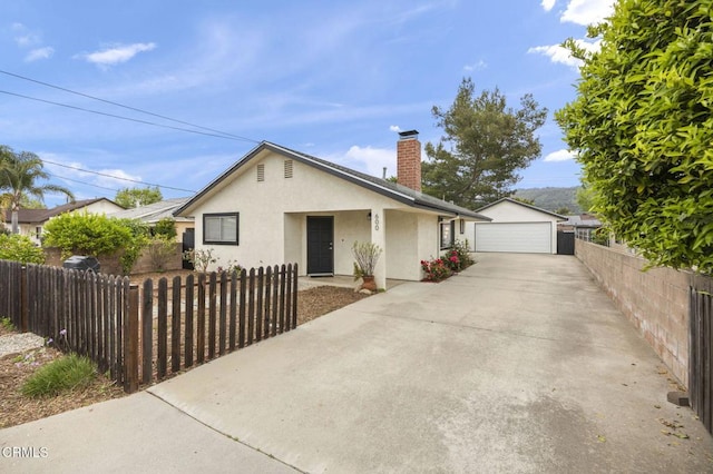 600 Good Hope St, Oak View, CA 93022 - view of front of home with stucco siding, a chimney, a detached garage, and a fenced front yard