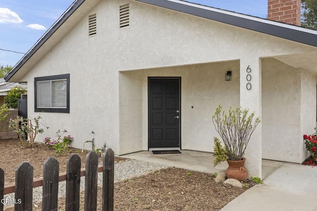 600 Good Hope St, Oak View, CA 93022 - view of exterior entry featuring stucco siding and a chimney