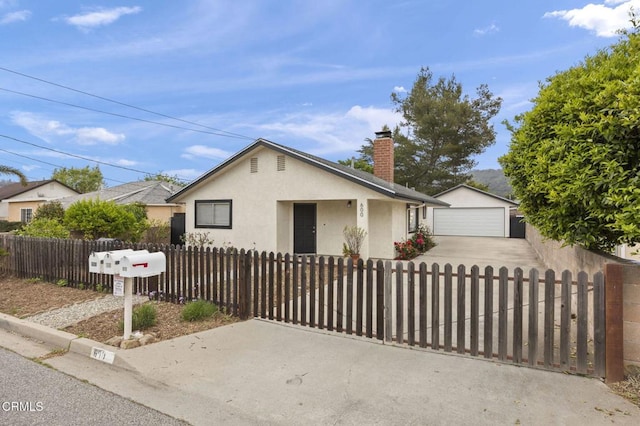 600 Good Hope St, Oak View, CA 93022 - ranch-style home with stucco siding, a chimney, a fenced front yard, a detached garage, and concrete driveway