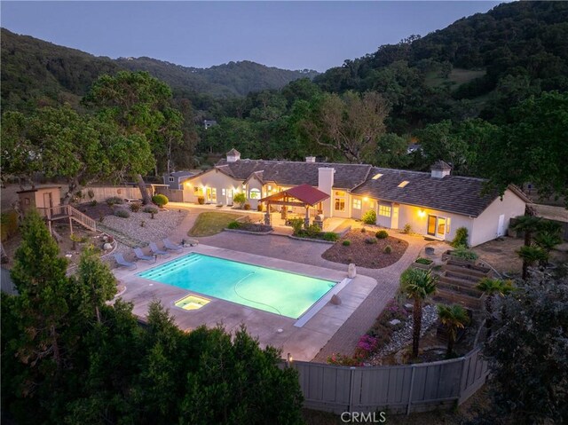 11620 Cenegal Rd, Atascadero, CA 93422 - swimming pool featuring a wooded view, fence, a mountain view, and a patio area