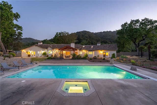 11620 Cenegal Rd, Atascadero, CA 93422 - pool at dusk with an in-ground hot tub, a patio area, an outdoor pool, and fence