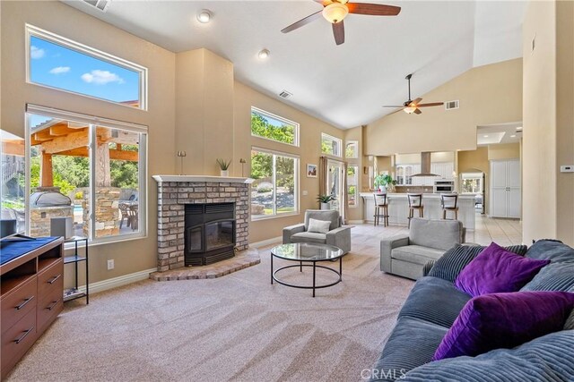11620 Cenegal Rd, Atascadero, CA 93422 - living area with ceiling fan, high vaulted ceiling, light carpet, baseboards, and a brick fireplace