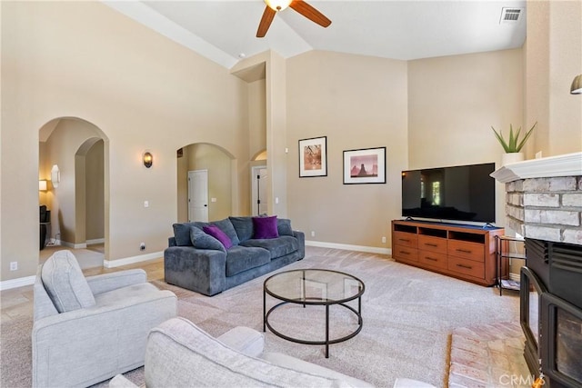 11620 Cenegal Rd, Atascadero, CA 93422 - living room featuring arched walkways, ceiling fan, light carpet, high vaulted ceiling, and baseboards