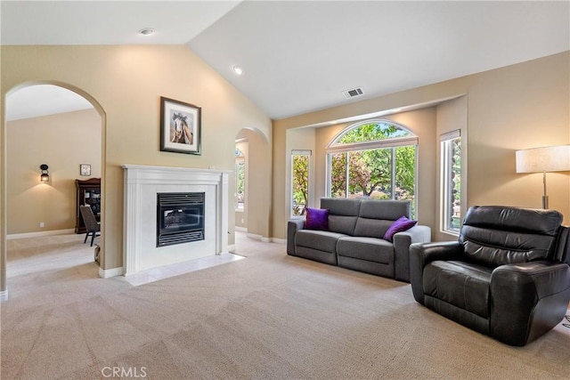 11620 Cenegal Rd, Atascadero, CA 93422 - living area with arched walkways, carpet flooring, baseboards, a fireplace with flush hearth, and high vaulted ceiling