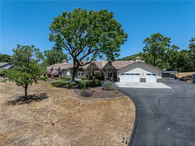 11620 Cenegal Rd, Atascadero, CA 93422 - ranch-style house with a garage, asphalt driveway, and stucco siding