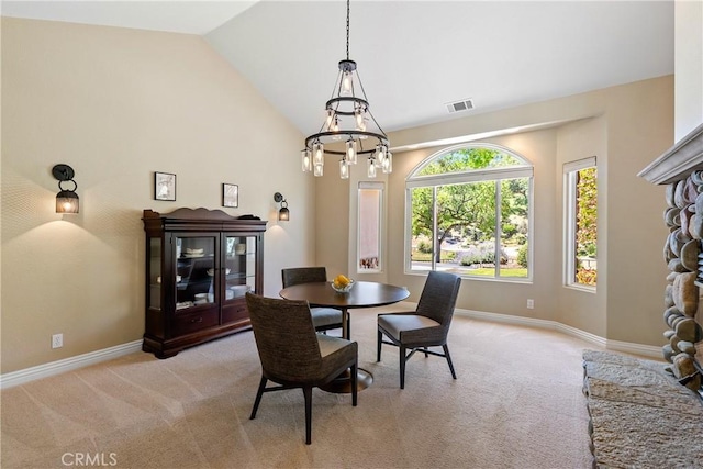 11620 Cenegal Rd, Atascadero, CA 93422 - dining area with light colored carpet, a chandelier, baseboards, and high vaulted ceiling