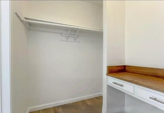 2309 Hauser Blvd, Los Angeles, CA 90016 - walk in closet with wood finished floors