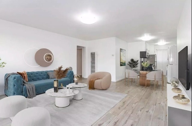 2309 Hauser Blvd, Los Angeles, CA 90016 - living room with light wood finished floors and a heating unit