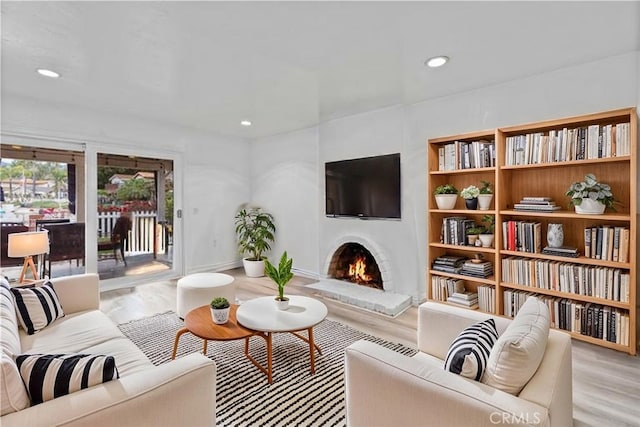 1558 Camelot Dr, Corona, CA 92882 - living room featuring wood finished floors, a lit fireplace, and recessed lighting