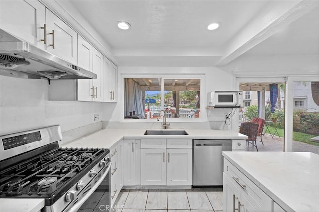 1558 Camelot Dr, Corona, CA 92882 - kitchen featuring stainless steel appliances, under cabinet range hood, a sink, light countertops, and recessed lighting