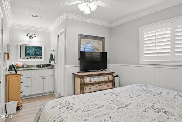 10440 N Karen Ave, Oak View, CA 93022 - bedroom featuring light wood-style floors, ornamental molding, a wainscoted wall, a sink, and ceiling fan