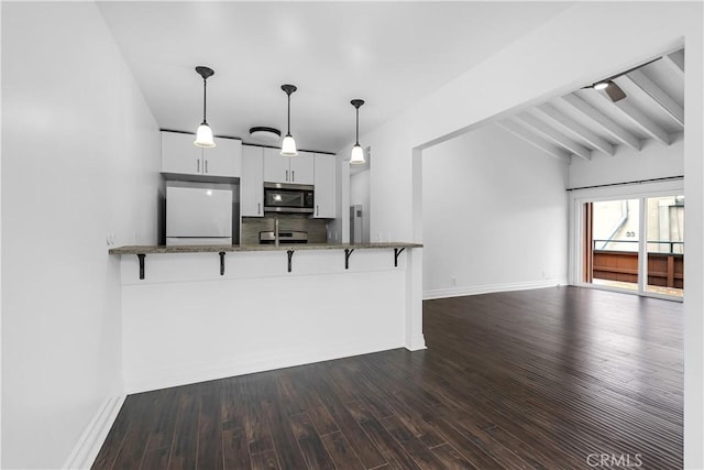 1001 W Stevens Ave W Unit 202, Santa Ana, CA 92707 - kitchen with stainless steel appliances, a kitchen breakfast bar, stone counters, tasteful backsplash, and white cabinets