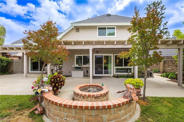 8435 Sale Ave, West Hills, CA 91304 - rear view of property featuring an outdoor fire pit, stucco siding, a patio area, and roof with shingles