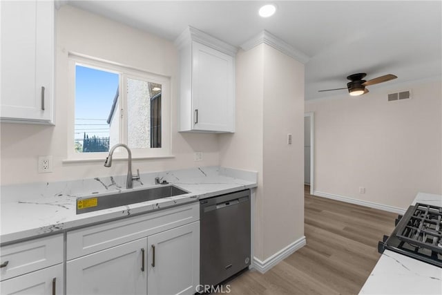 8990 19th St Unit 376, Rancho Cucamonga, CA 91701 - kitchen with dishwasher, a sink, white cabinets, baseboards, and ceiling fan