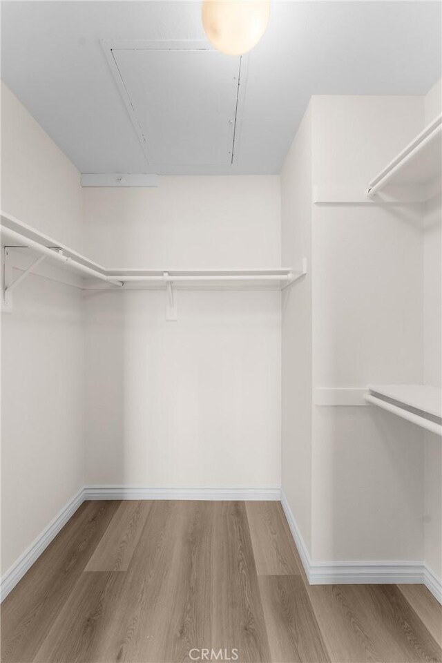 8990 19th St Unit 376, Rancho Cucamonga, CA 91701 - walk in closet featuring attic access and wood finished floors