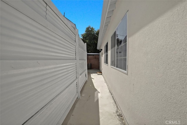 view of home's exterior featuring stucco siding and fence