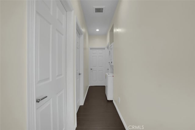 corridor featuring recessed lighting, baseboards, and dark wood-type flooring