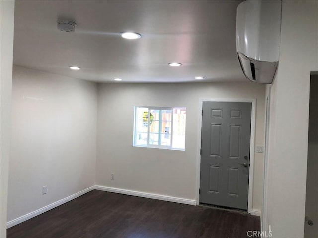 entrance foyer featuring dark wood-style flooring, baseboards, and recessed lighting