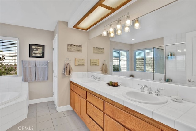 11020 Blue Jay Way, Oak Hills, CA 92344 - full bath with tile patterned floors, a bath, double vanity, baseboards, and tiled shower