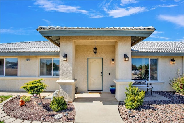 11020 Blue Jay Way, Oak Hills, CA 92344 - doorway to property with stucco siding and a tile roof