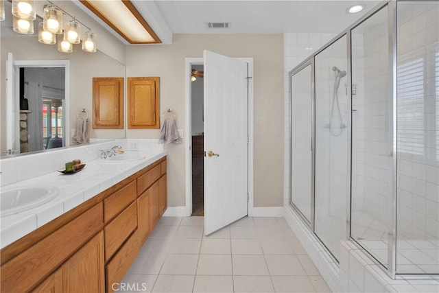 11020 Blue Jay Way, Oak Hills, CA 92344 - full bathroom featuring a shower stall, double vanity, tile patterned floors, and baseboards