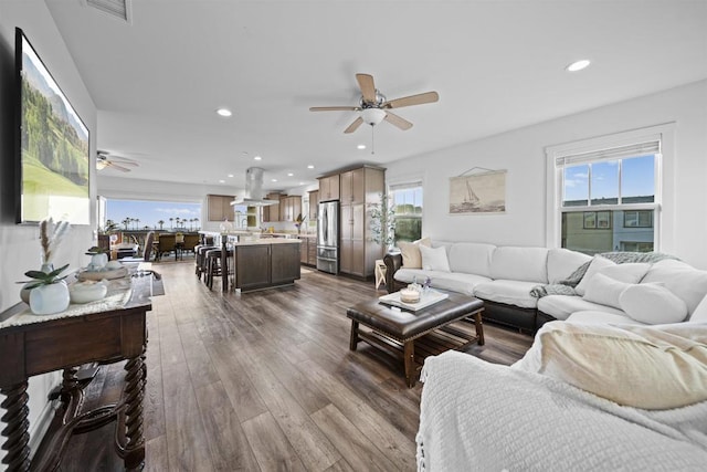 living area with a ceiling fan, hardwood / wood-style floors, and recessed lighting