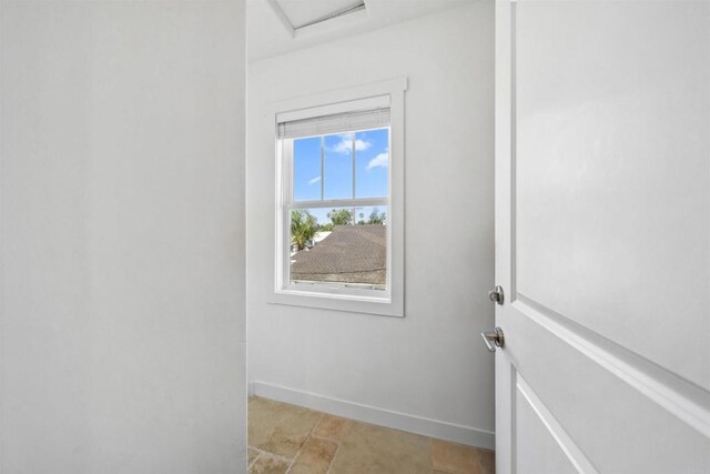 doorway featuring baseboards