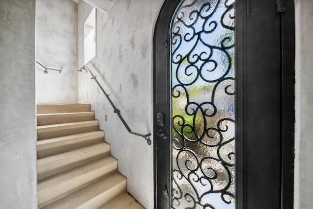 stairway featuring arched walkways