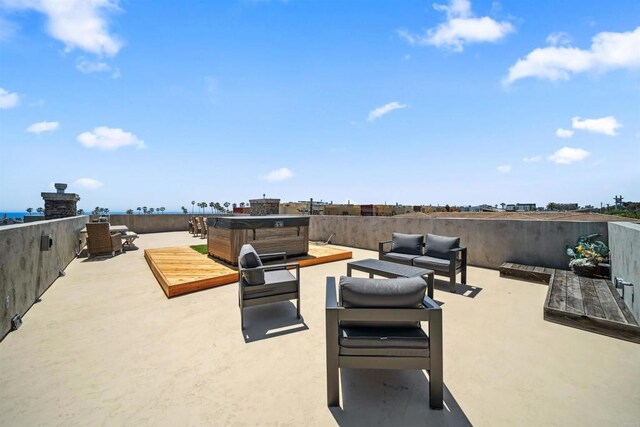 view of patio featuring an outdoor living space and a hot tub