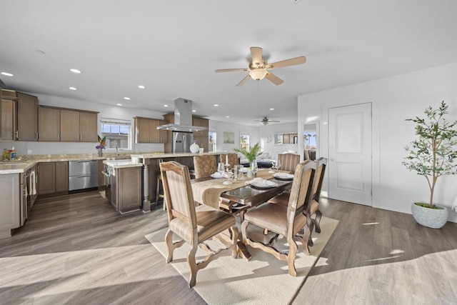 dining space featuring a ceiling fan, recessed lighting, and wood finished floors