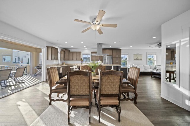 dining room with a ceiling fan, healthy amount of natural light, recessed lighting, and dark wood-type flooring