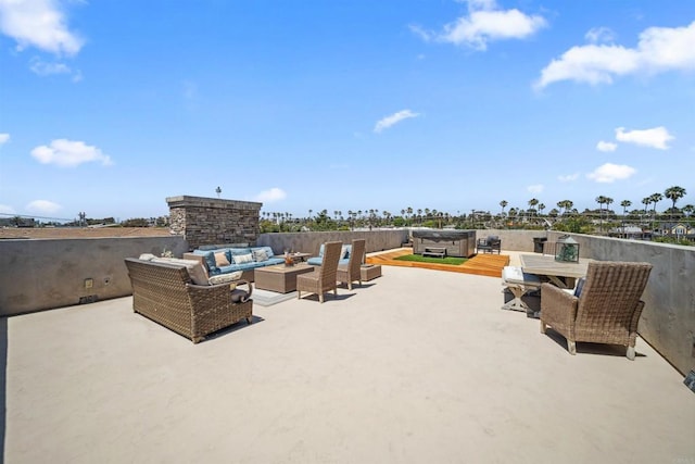 view of patio with a hot tub, an outdoor hangout area, and outdoor dining space
