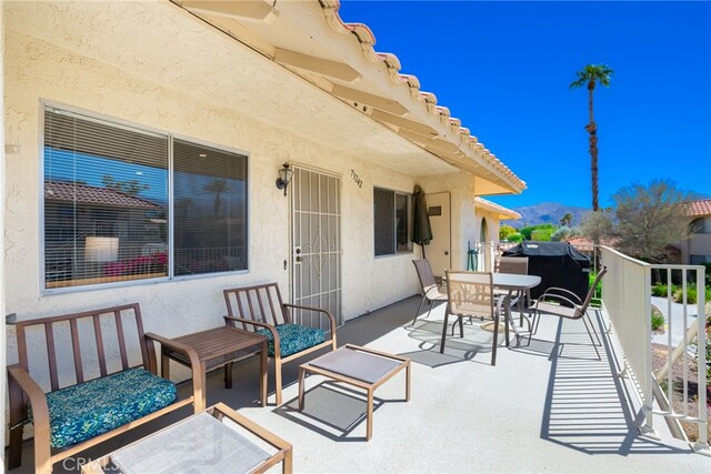 view of patio / terrace with outdoor dining area and a mountain view