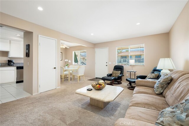 living area featuring light carpet and recessed lighting