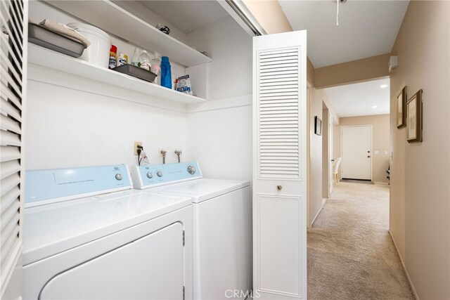 washroom featuring light carpet and washing machine and dryer
