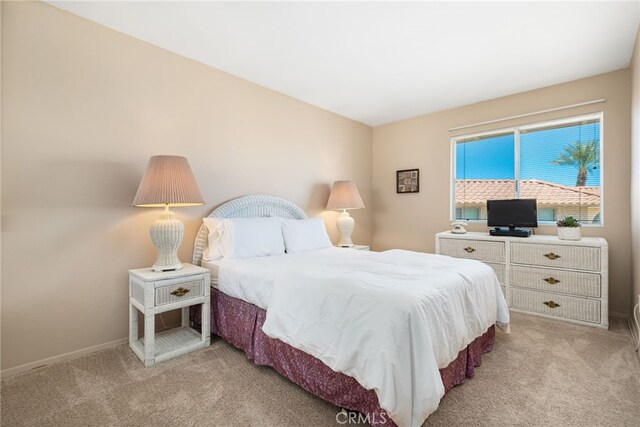 bedroom with carpet and baseboards